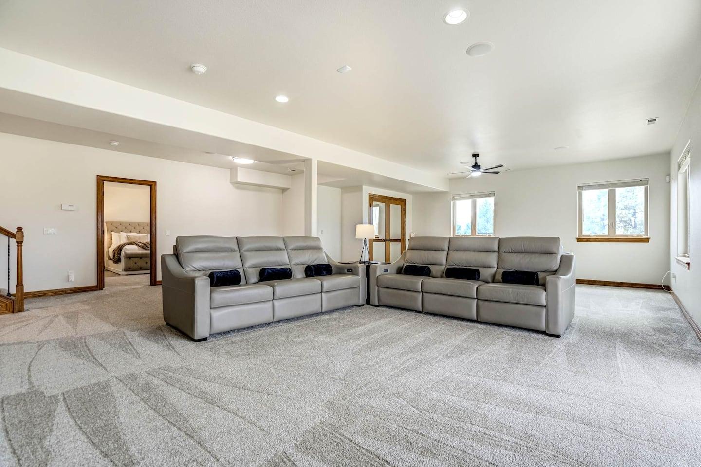 Lower-level movie lounge with oversized leather motion seats